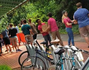 Students of the So Percussion Summer Institute in residence at Princeton University, form a line to pass the 31,000 mac'n'cheese meals they packed for Arm In Arm's pantry customers.